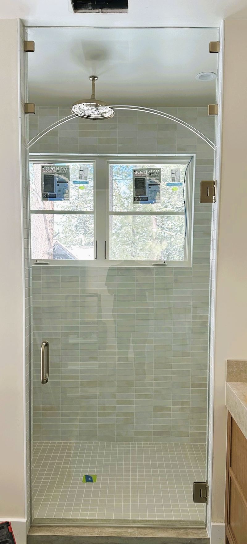 Clear tempered glass hinged shower door with arched top transom, satin brass hardware, Gastonia NC