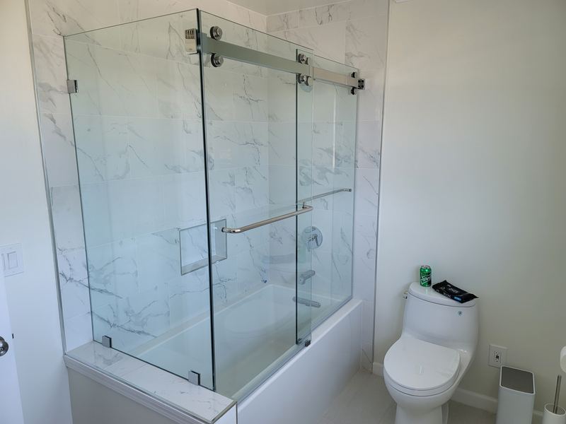 Clear tempered glass frameless sliding tub door, chrome hardware, Belmont NC